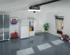 An organized garage with an overhead LiftMaster lighting system, a white refrigerator, and wall-mounted lawn tools